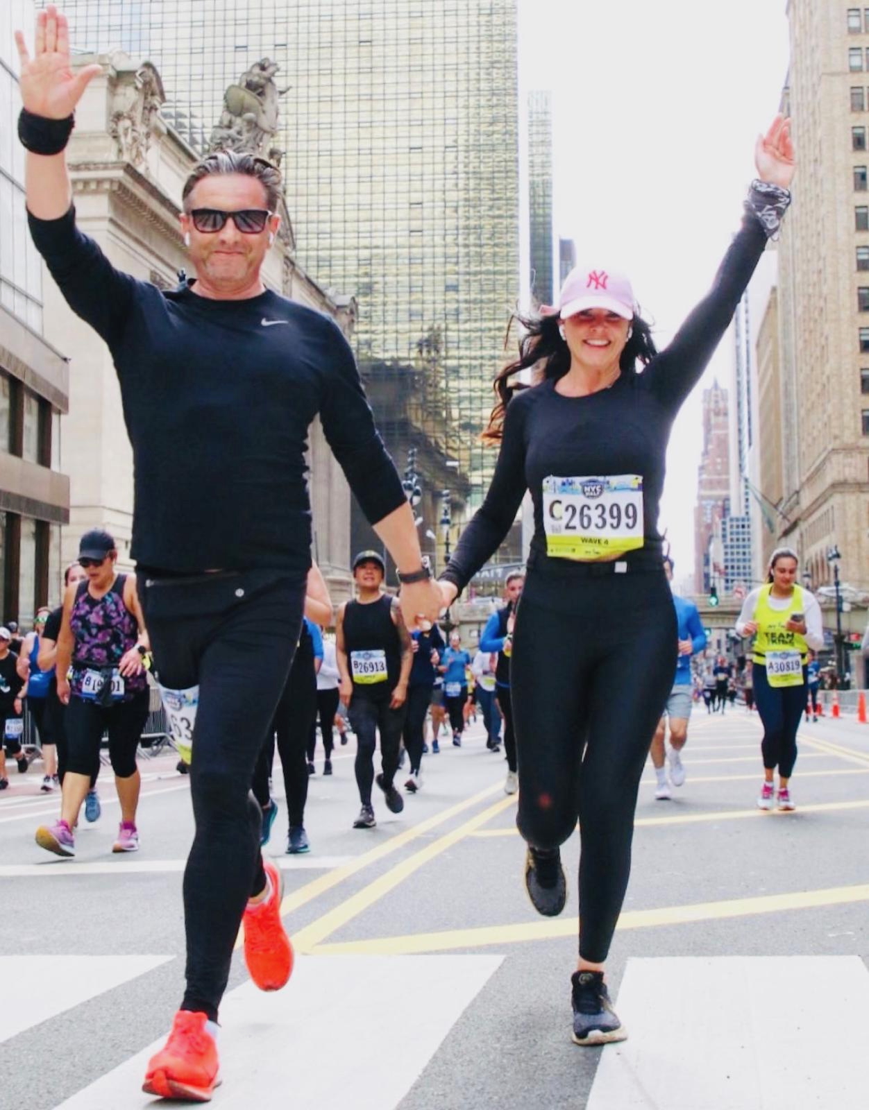 Christoph and Rachel running hand in hand through New York, both raising an arm