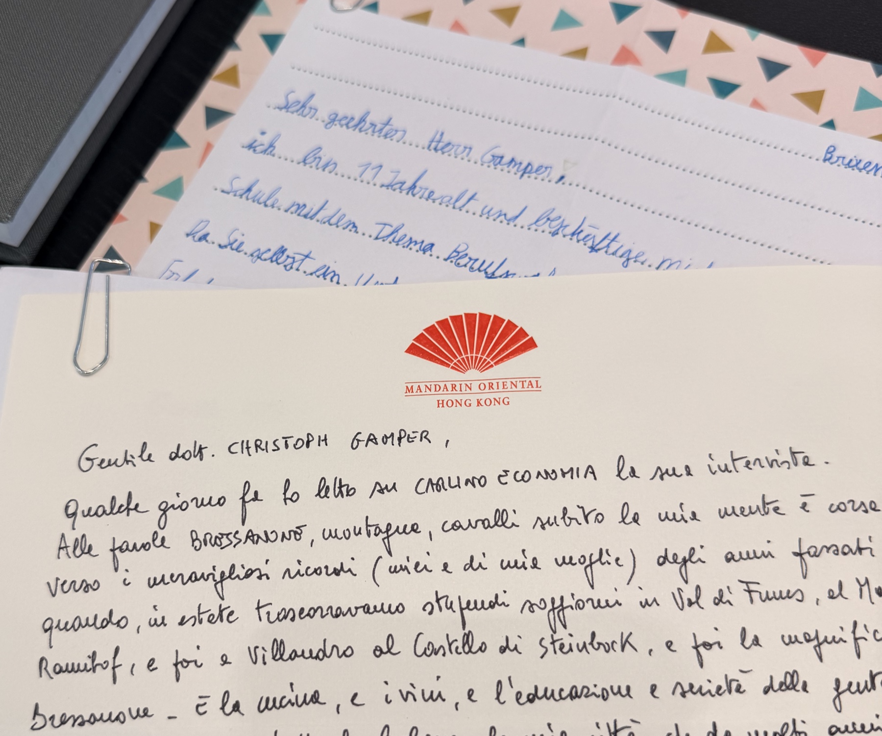 Two overlapping handwritten letters, one on Mandarin Oriental Hong Kong paper with a red fan. Sender names and signatures are outside the crop.